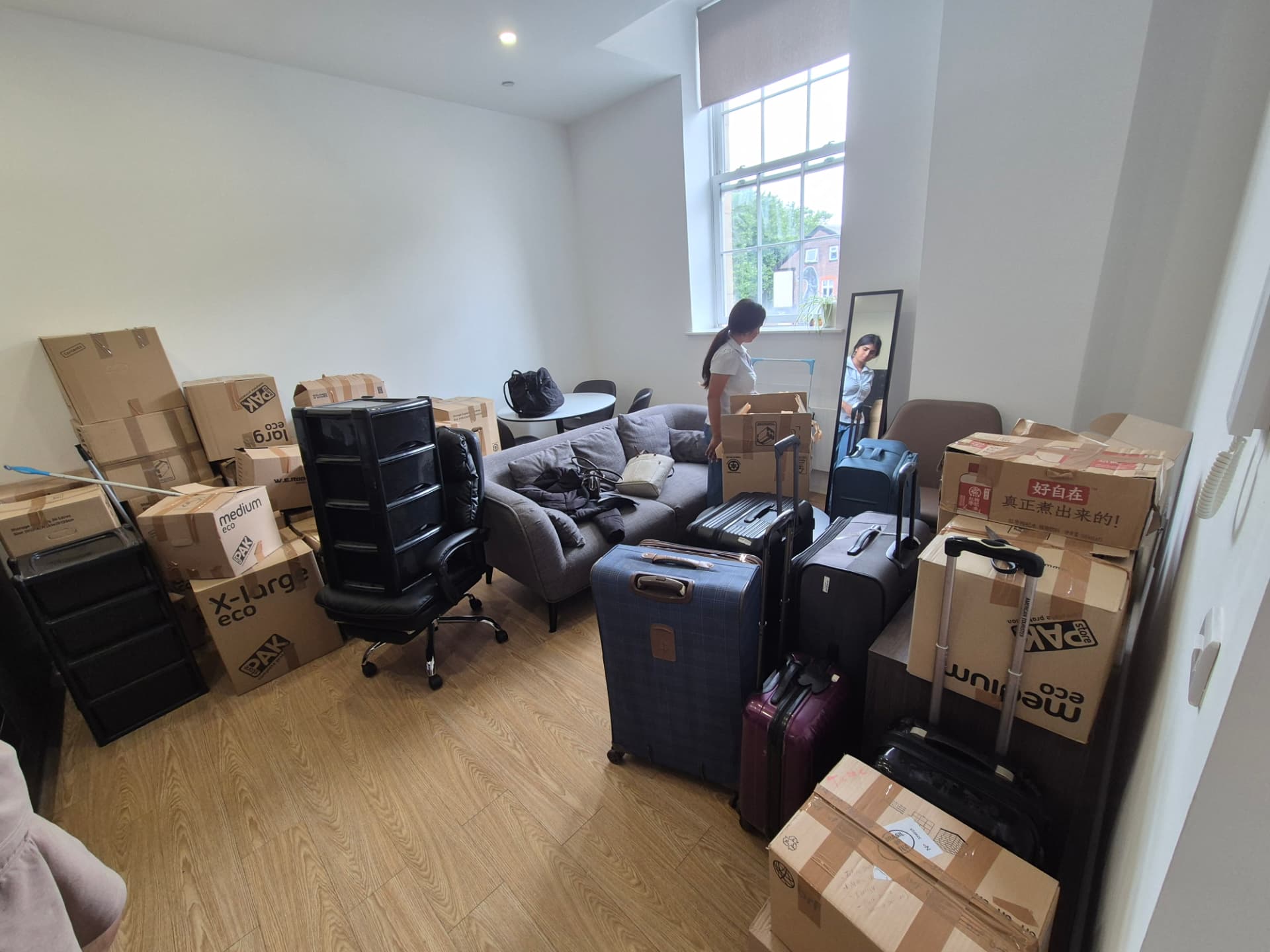 Customer checking boxes and suitcases delivered into a newly rented apartment living room