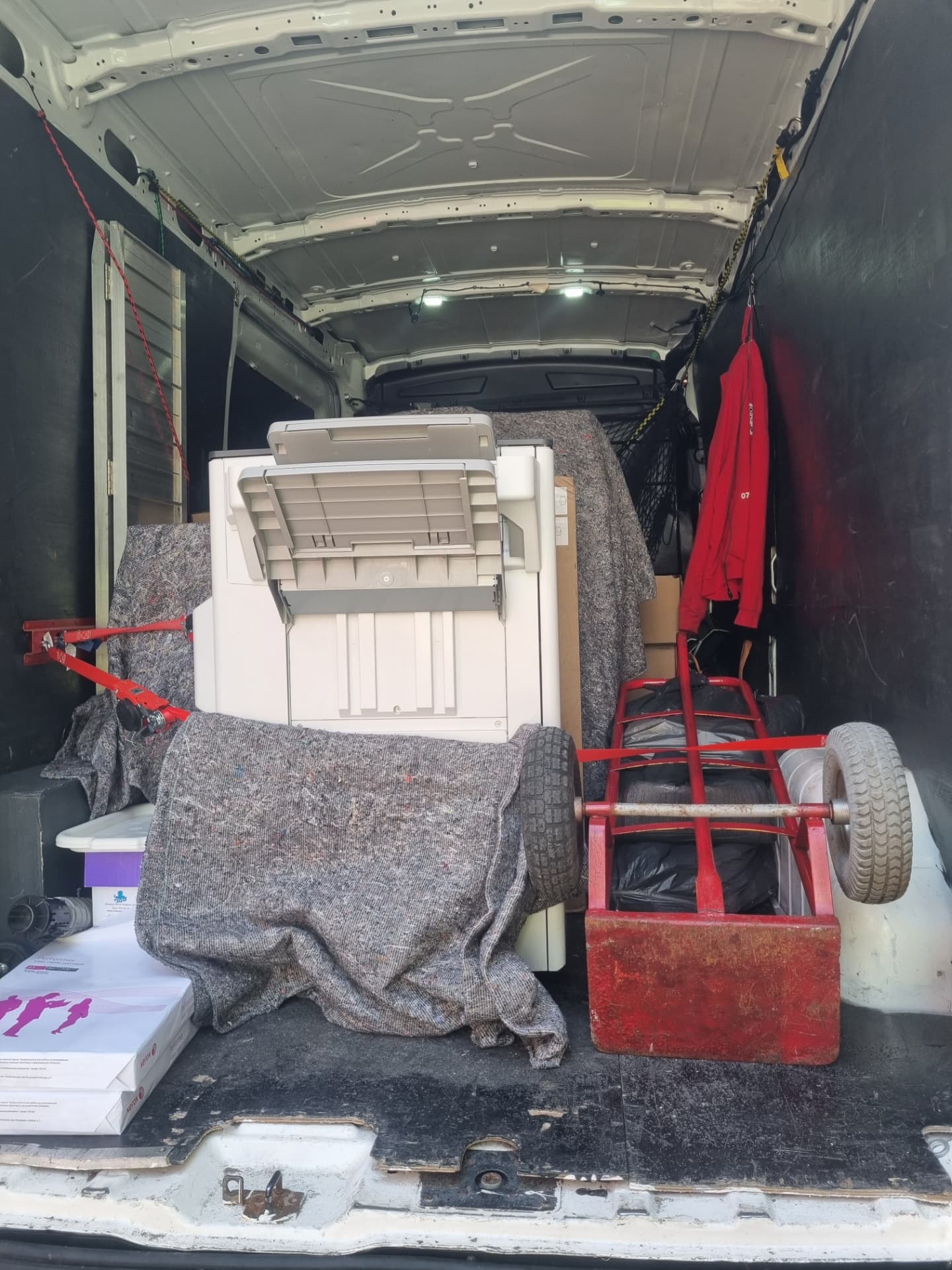 Office printer, filing cabinets and archive boxes blanket-wrapped and secured inside the removals van