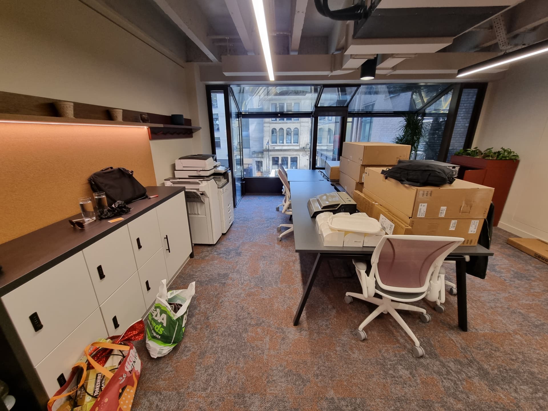 Open plan office with desks, lockers and packed boxes ready for an out-of-hours business relocation