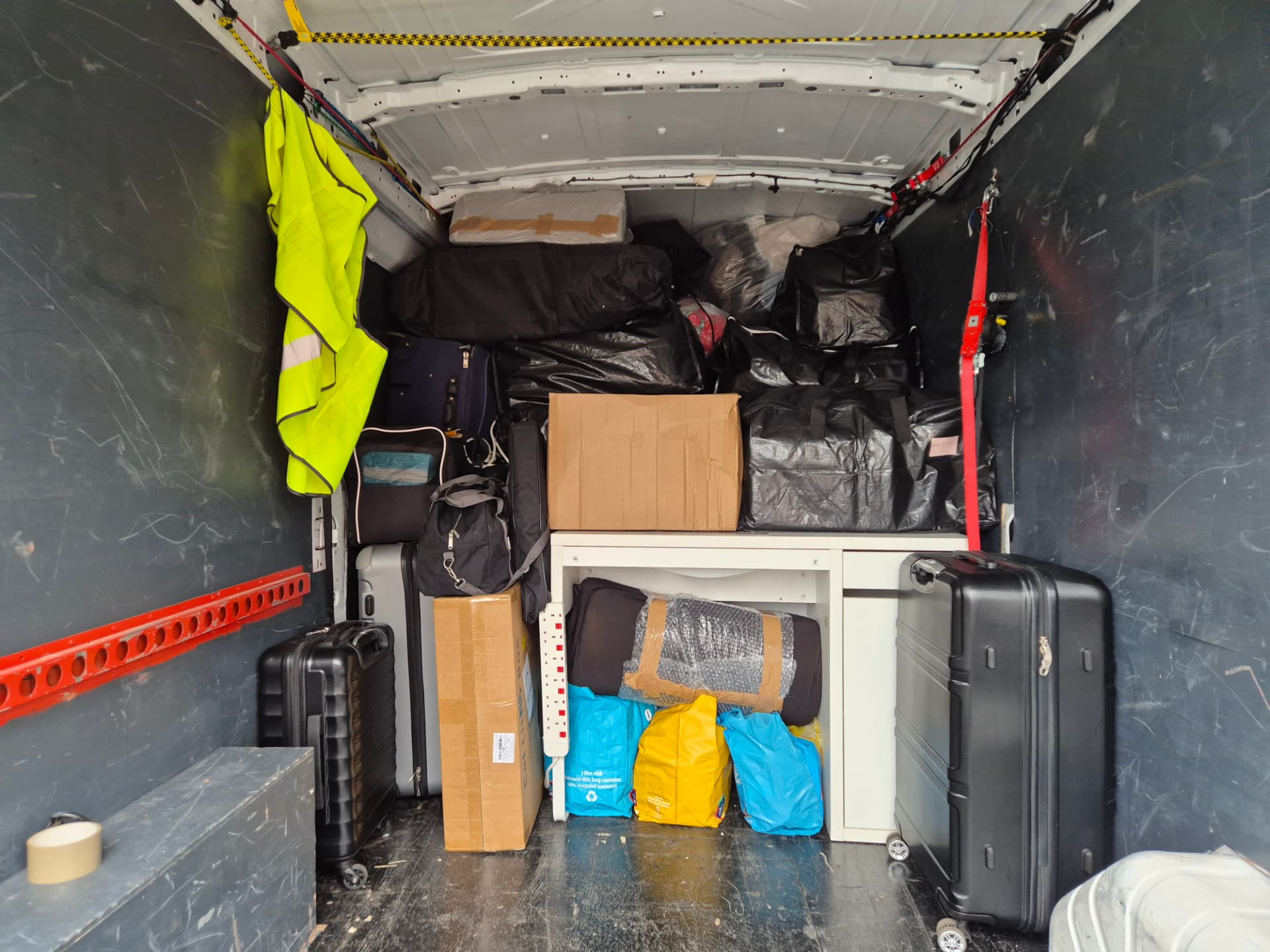 Apartment contents strapped and stacked securely inside the removals van with ratchet straps