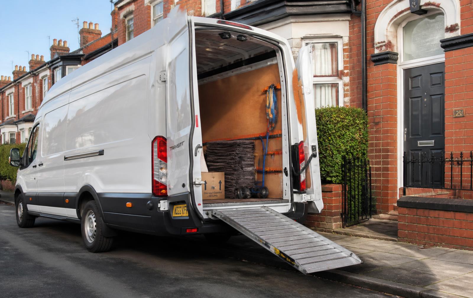 Wigan Man & Van Ford Transit LWB van loaded outside a Manchester terraced house